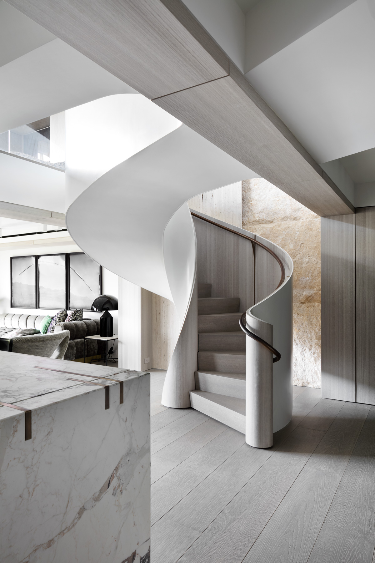 Elegant curved staircase inside high-end residential duplex